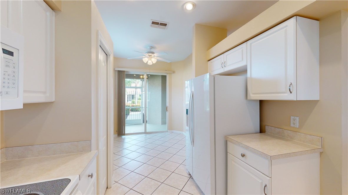 21540 Portrush Run Estero, FL 33928 - Photo 22 of 32 a view of a kitchen from the hallway