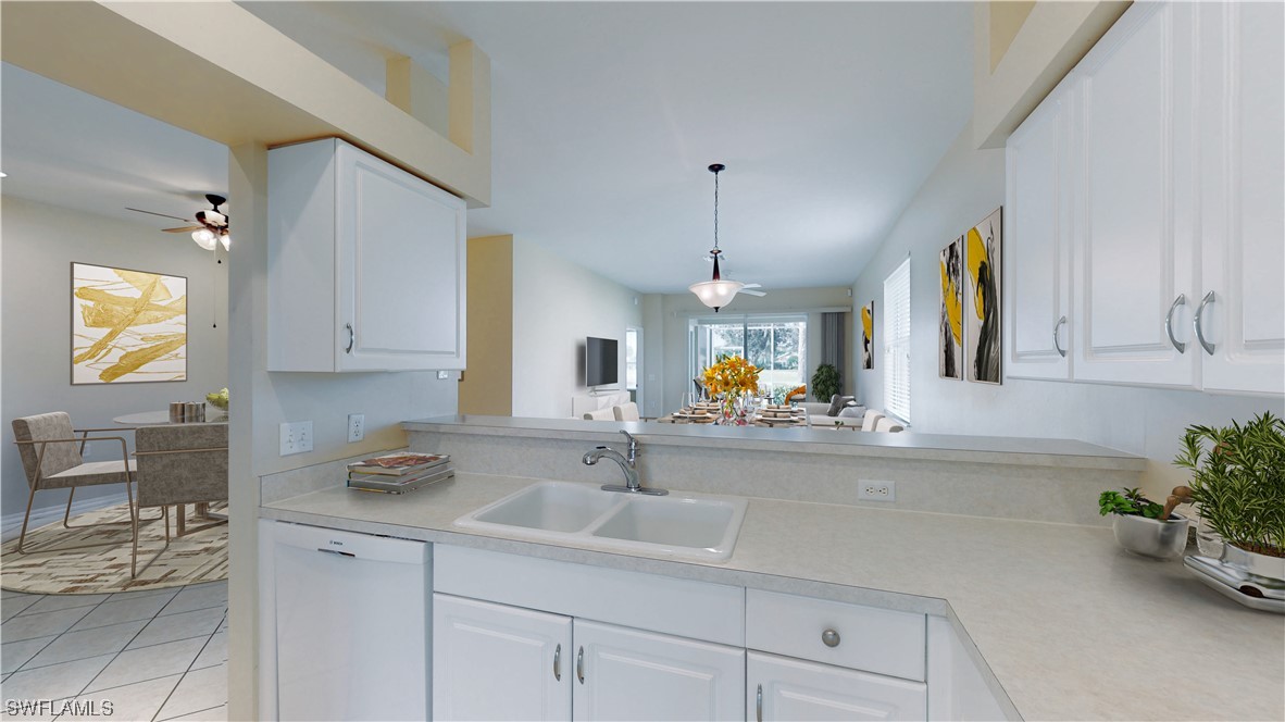 21540 Portrush Run Estero, FL 33928 - Photo 3 of 32 a kitchen with a sink and cabinets