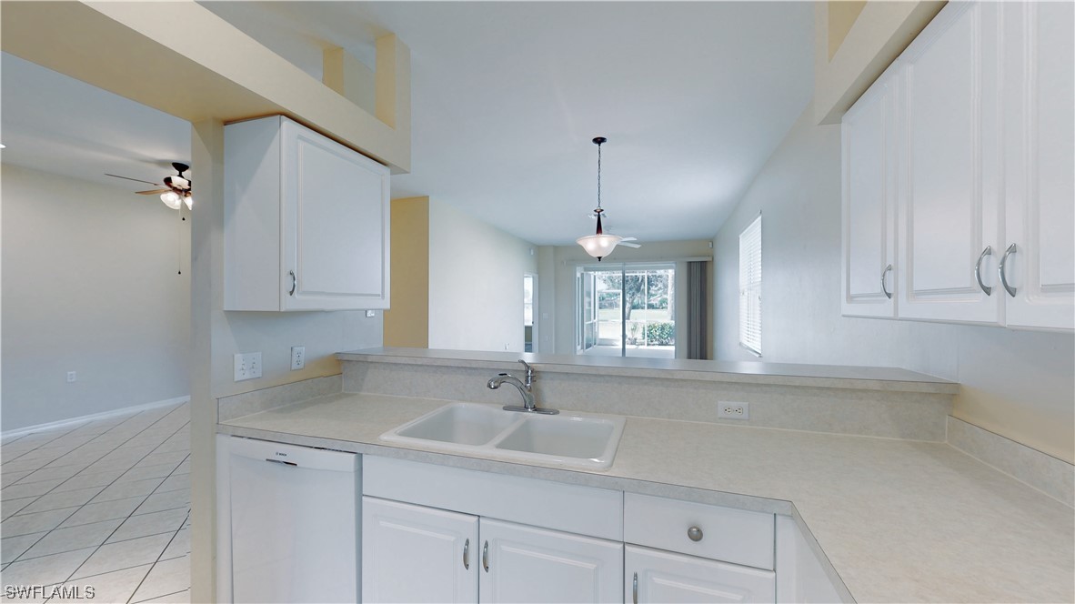 21540 Portrush Run Estero, FL 33928 - Photo 4 of 32 a kitchen with a sink cabinets and window