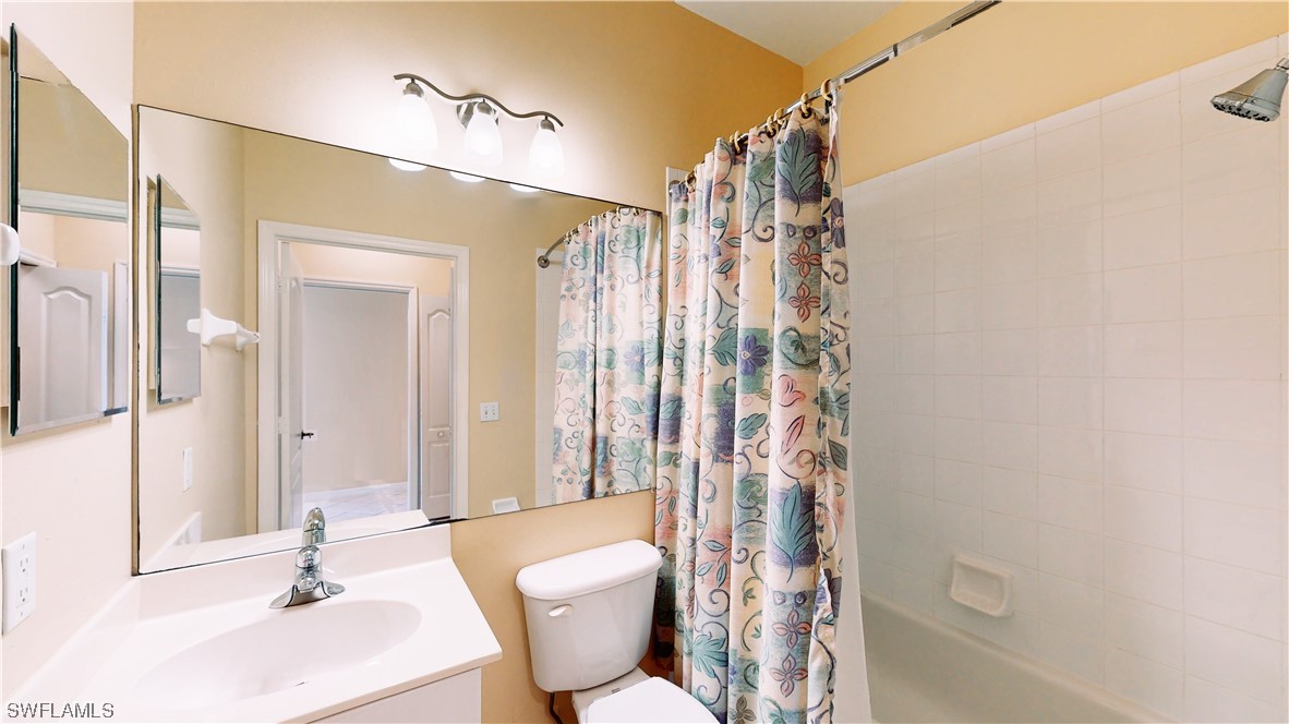 21540 Portrush Run Estero, FL 33928 - Photo 7 of 32 a bathroom with a sink a toilet a tub and shower