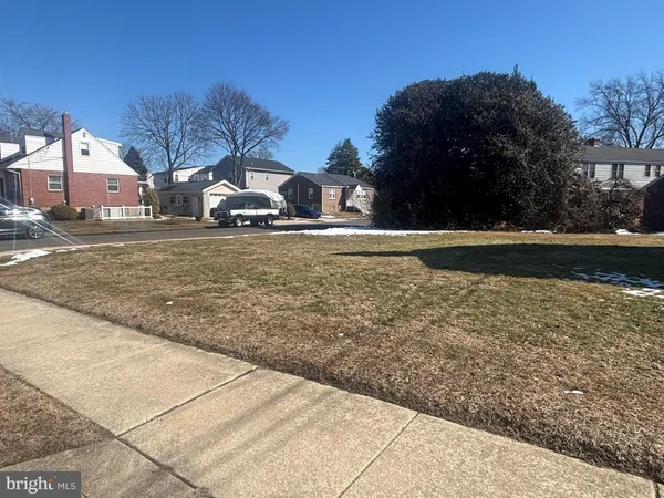 a front view of house with yard and car parked