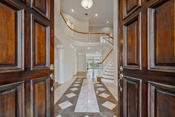 a view of entryway and hall with wooden floor