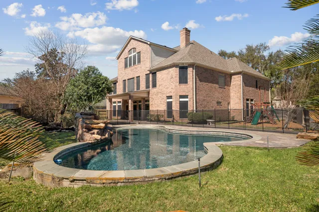 a view of a house with swimming pool and sitting area