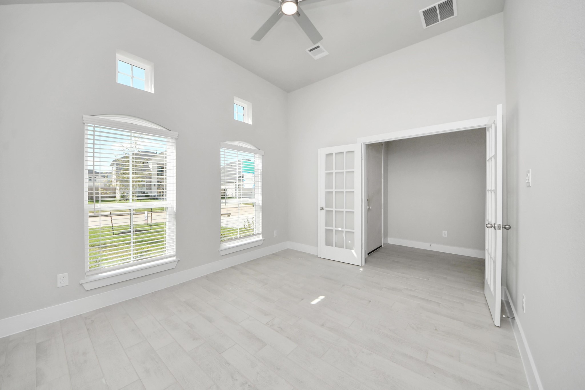 3042 Native Spg Drive Spring, TX 77373 - Photo 4 of 32 Experience the perfect blend of sophistication and warmth in this home office, boasting elegant wood-look tile flooring and flooded with natural light from expansive windows and French doors. Sample photo of completed home with similar floor plan. Actual colors and selections may vary.