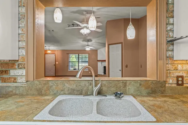 a view of a kitchen with wooden floor and a sink