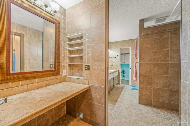 a bathroom with a shower and a sink