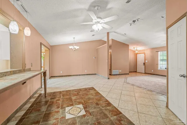 a view of a patio with a table and chairs under an umbrella