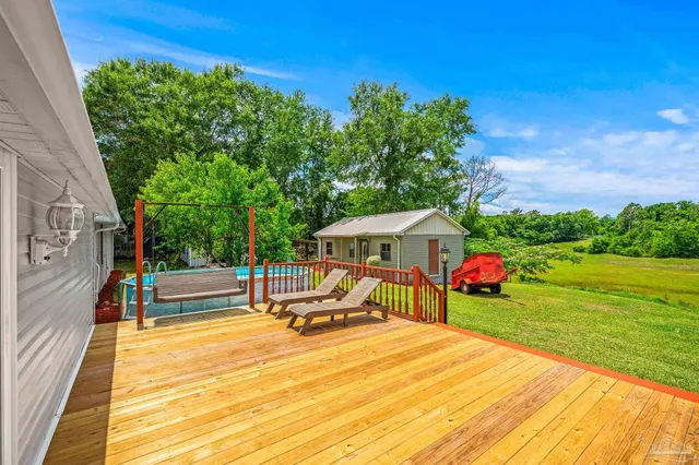 a view of a house with a backyard porch and sitting area