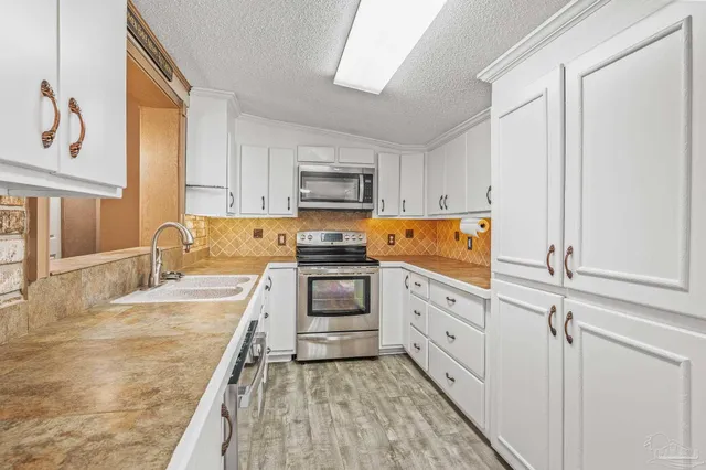 a bathroom with a granite countertop sink a large mirror and vanity