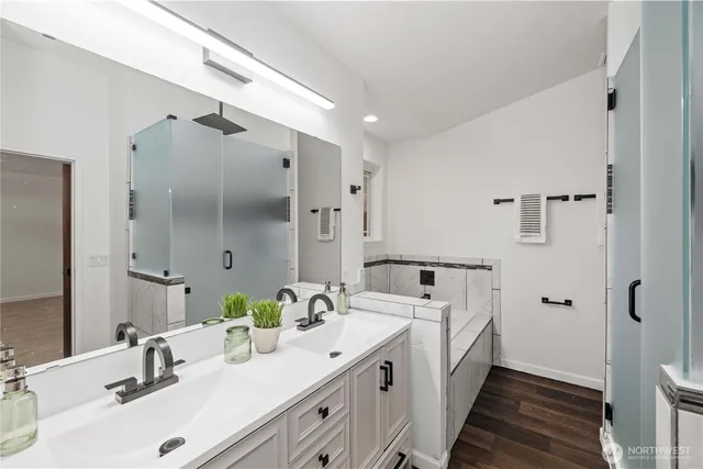 a bathroom with a double vanity sink mirror and shower