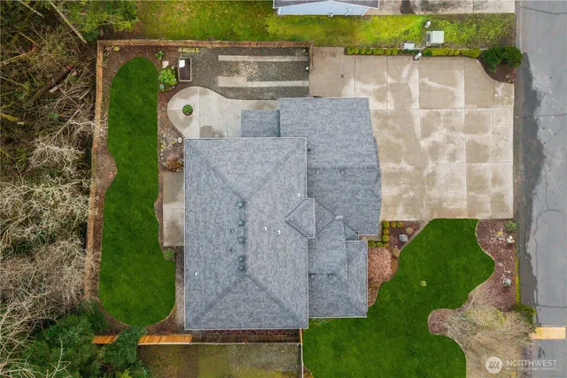 an aerial view of a house with a yard