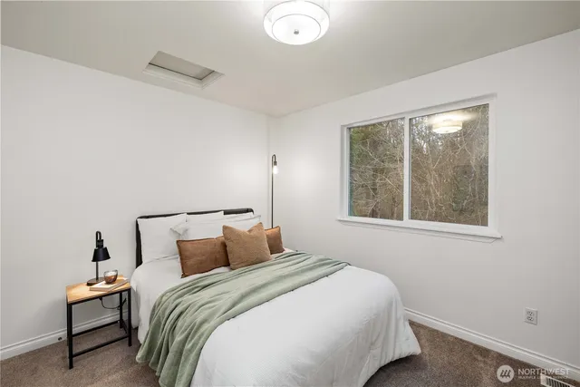 a bedroom with a bed and window