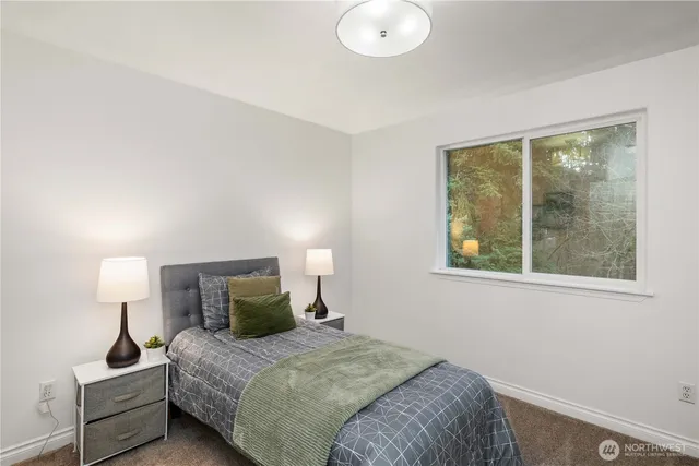 a bedroom with a bed and a lamp