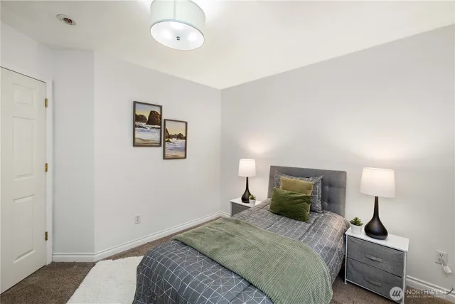 a bedroom with a bed and a lamp