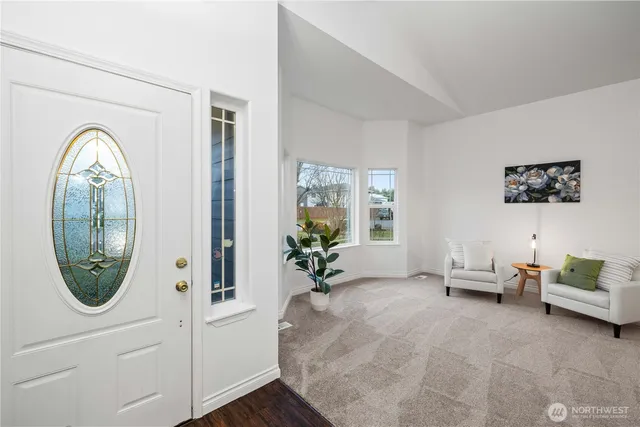 a living room with furniture and a mirror