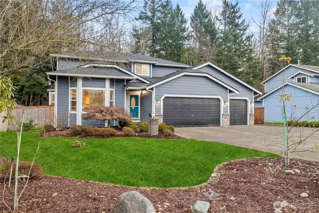 a front view of a house with a yard and garage
