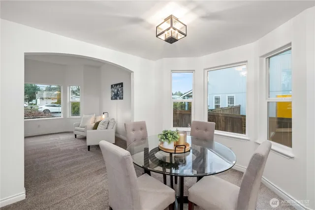 a view of a dining room with furniture wooden floor and a chandelier