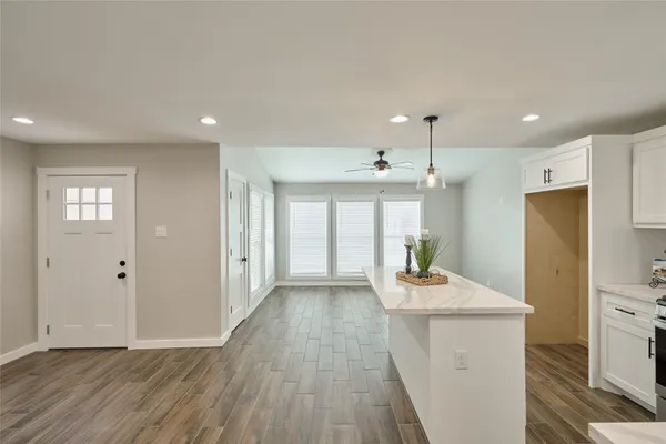 a dining room with furniture window wooden floor and a chandelier