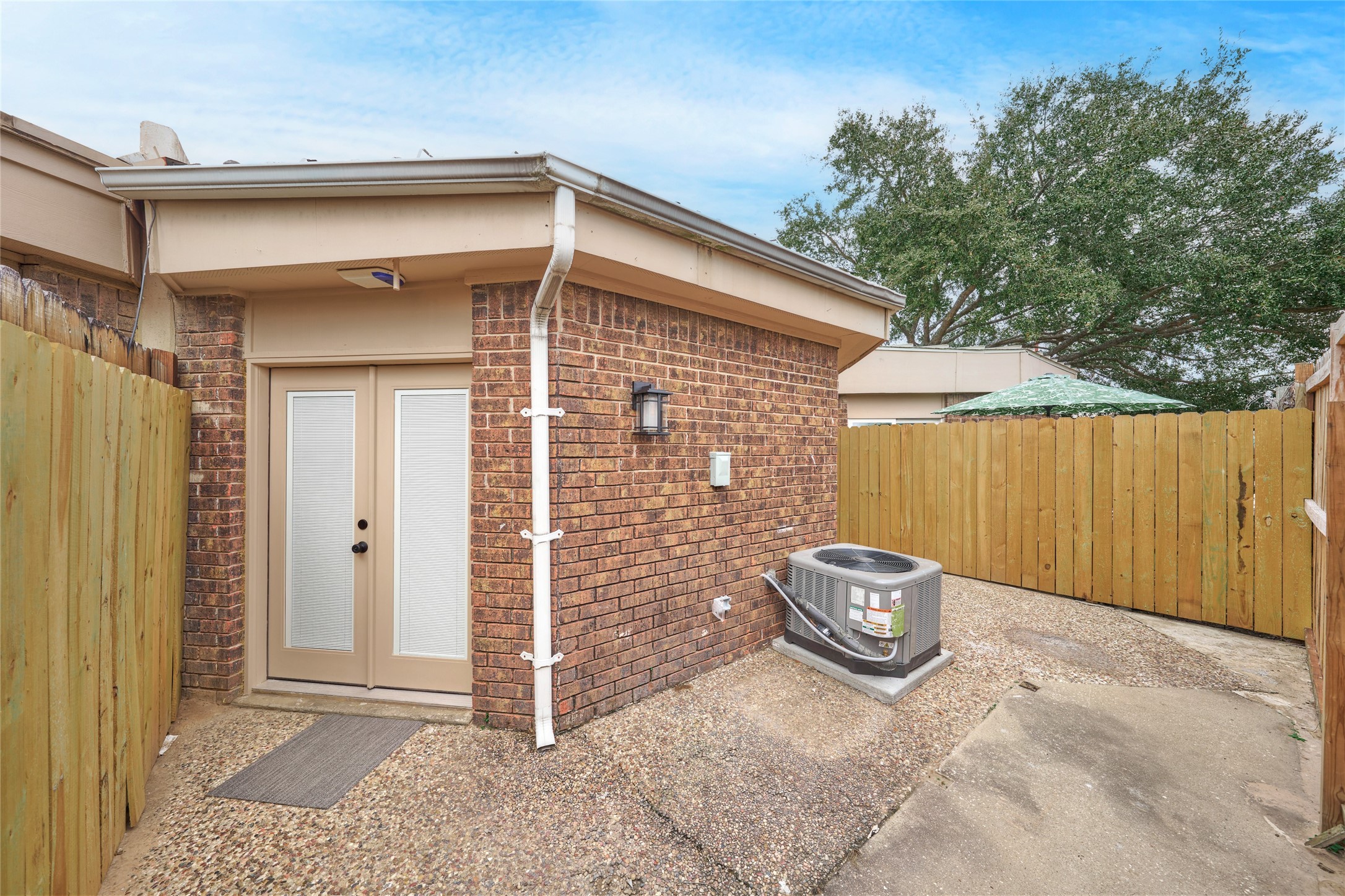 1014 Graham Drive, Unit L2 Tomball, TX 77375 - Photo 26 of 30 Patio off primary bedroom that shares with secondary bedroom to the right