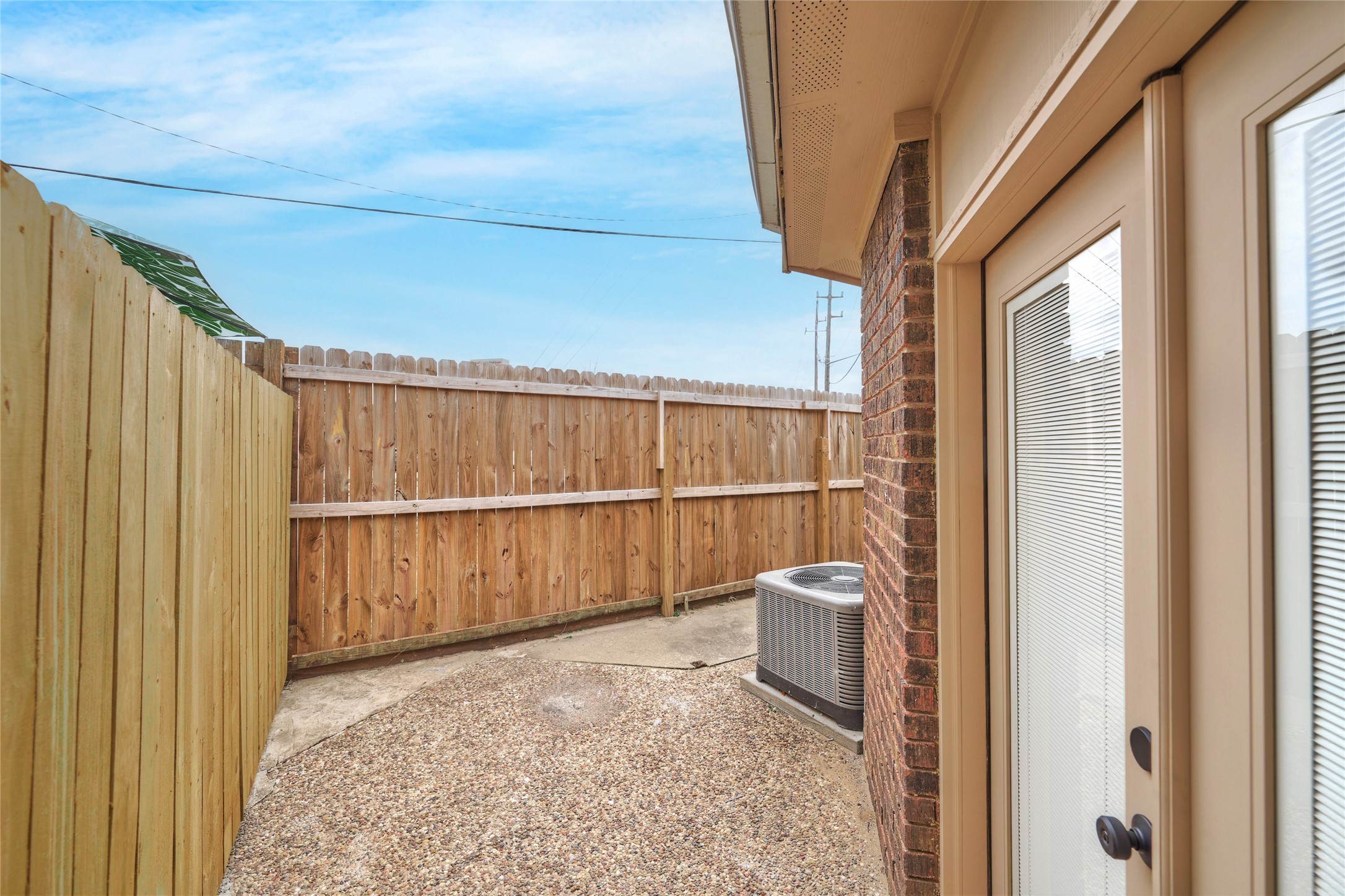 1014 Graham Drive, Unit L2 Tomball, TX 77375 - Photo 28 of 30 Secondary bedroom entry to shared patio space