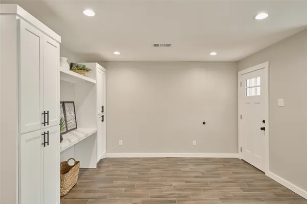 a view of a livingroom with wooden floor and staircase