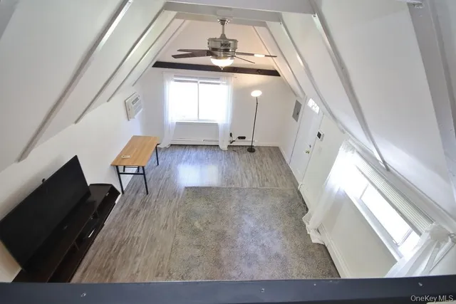 a view of a living room with furniture and a fireplace