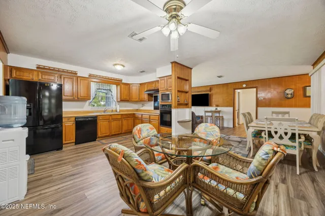 a backyard of a house with table and chairs