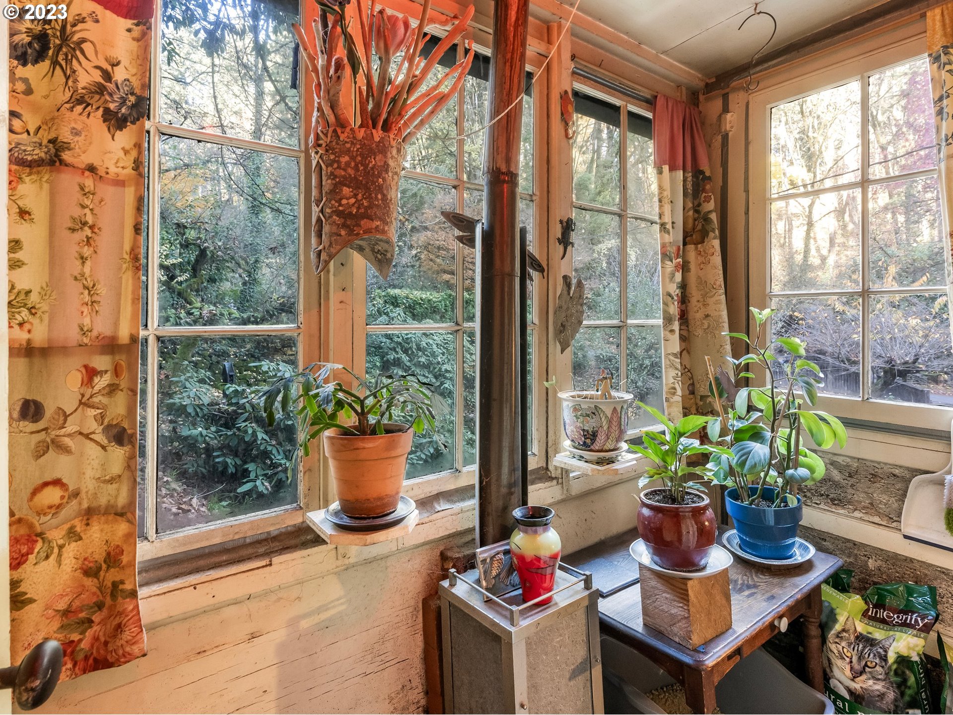 3852 Southwest Condor Avenue Portland, OR 97239 - Photo 14 of 44 a view of a porch with chairs and potted plants