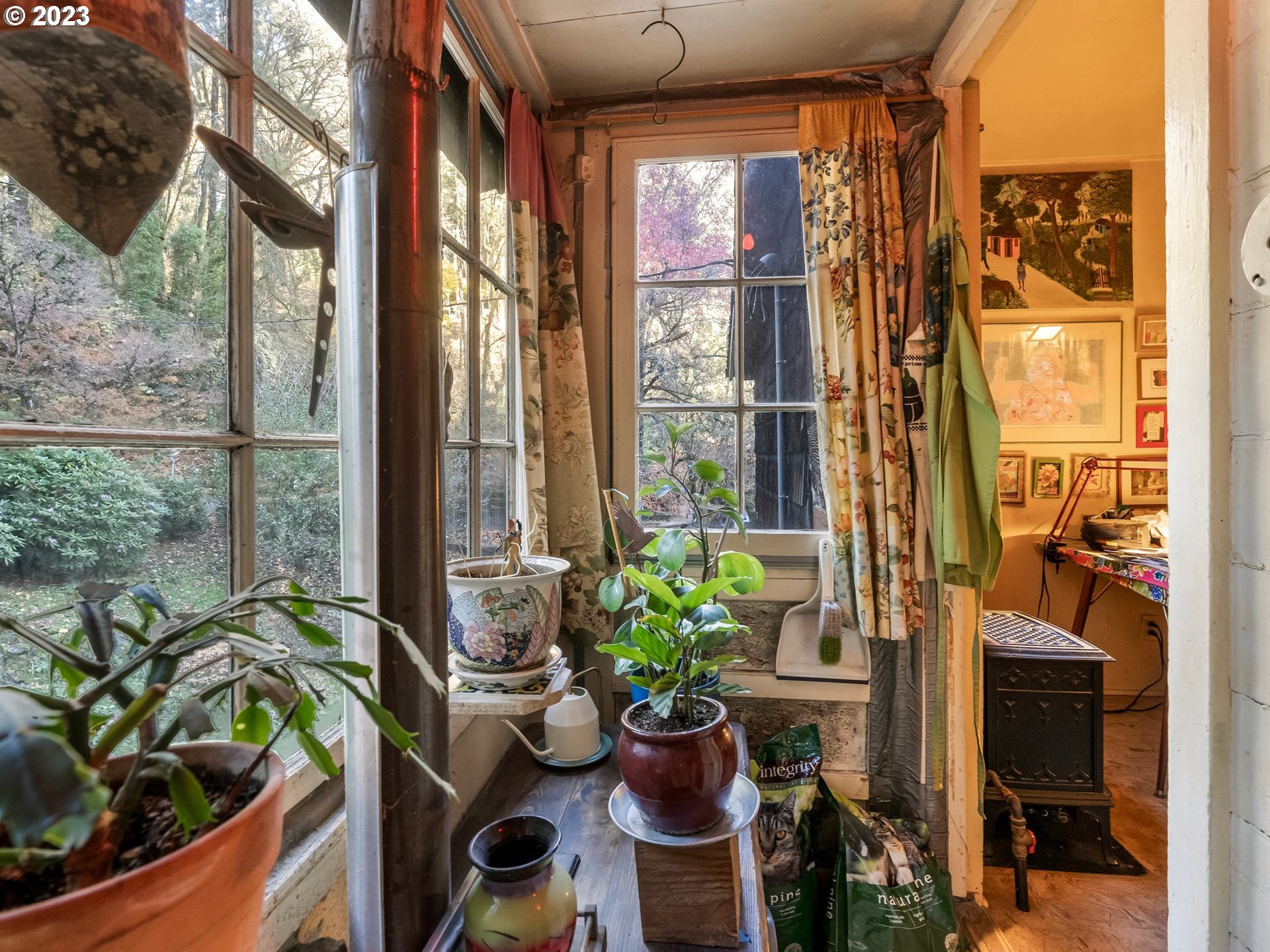 3852 Southwest Condor Avenue Portland, OR 97239 - Photo 15 of 44 a living room filled with furniture and a potted plant
