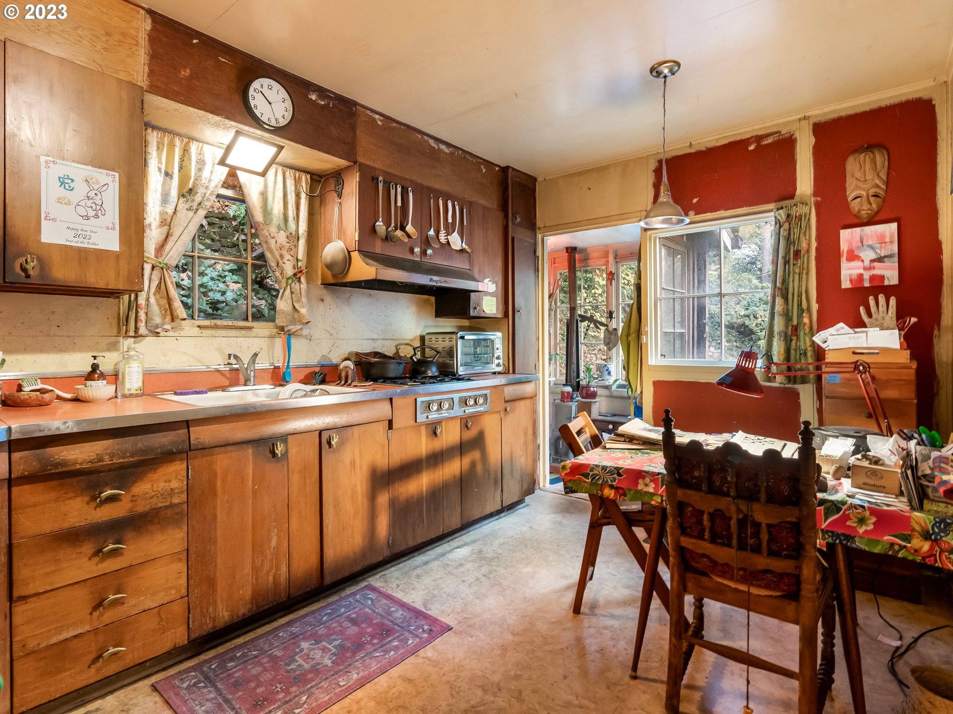 3852 Southwest Condor Avenue Portland, OR 97239 - Photo 16 of 44 a open kitchen with a table chairs and white cabinets