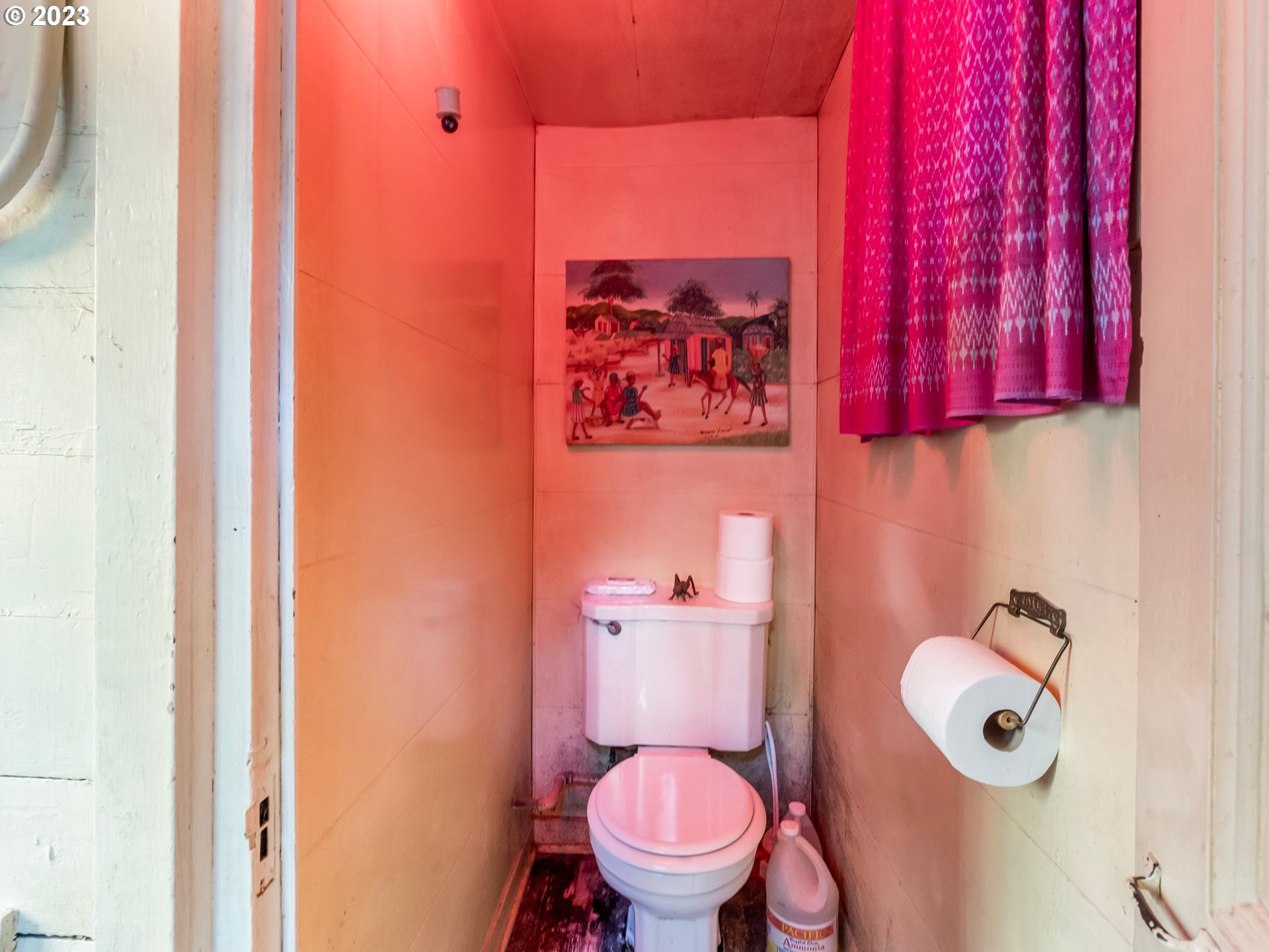 3852 Southwest Condor Avenue Portland, OR 97239 - Photo 20 of 44 a white toilet sitting next to a shower curtain