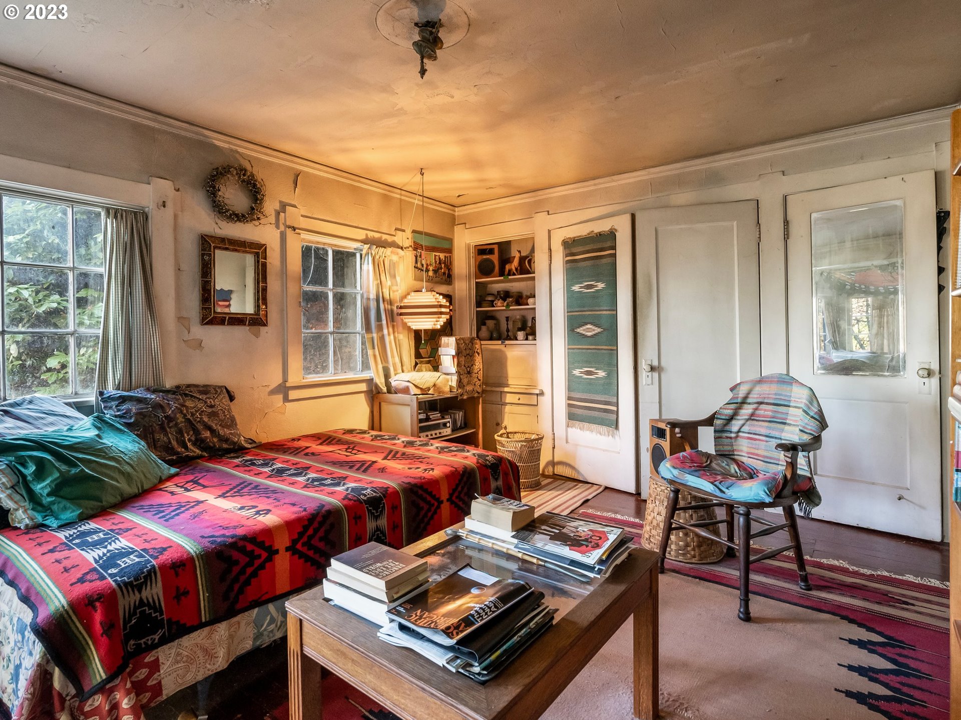 3852 Southwest Condor Avenue Portland, OR 97239 - Photo 26 of 44 a bedroom with a bed and wooden floor