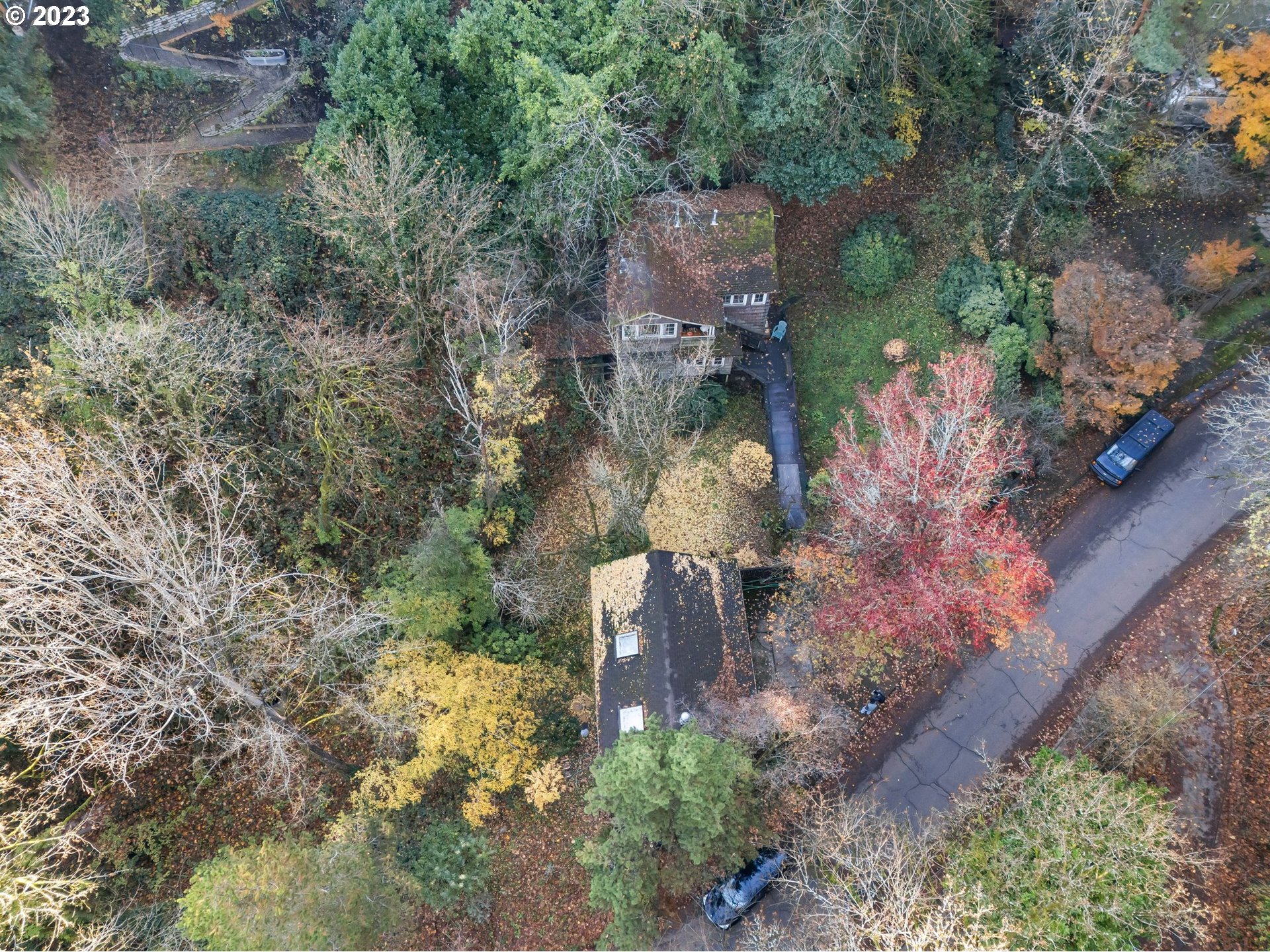 3852 Southwest Condor Avenue Portland, OR 97239 - Photo 7 of 44 an aerial view of a house with a yard and large trees