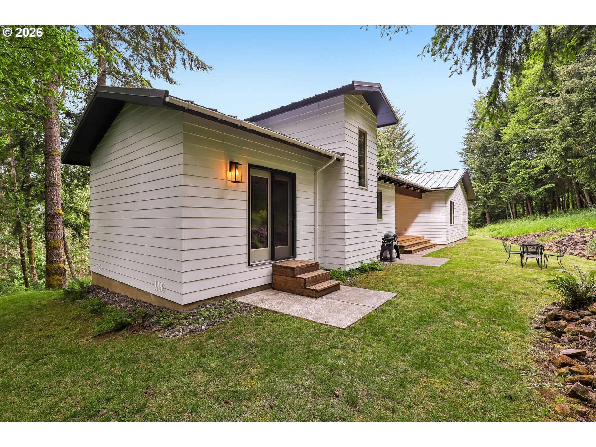 873 Mountain View Road Kalama, WA 98625 - Photo 32 of 45 a view of a backyard with plants and a patio