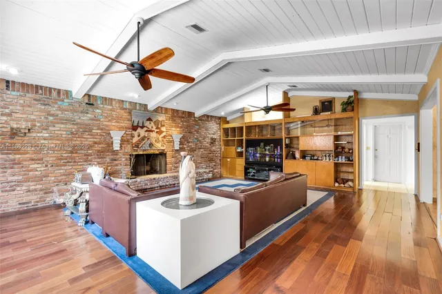 a kitchen with stainless steel appliances granite countertop a stove and a wooden floors