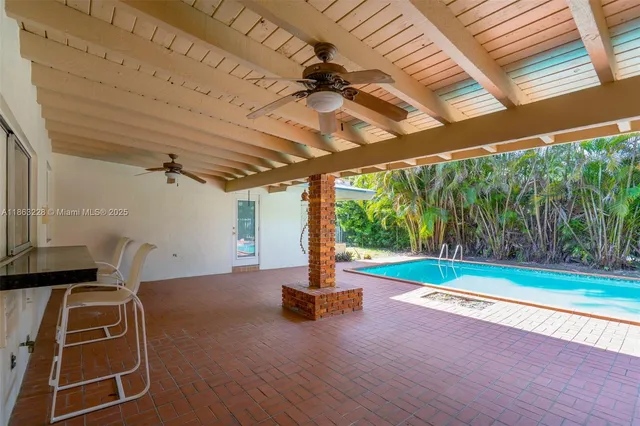 a view of a backyard with swimming pool