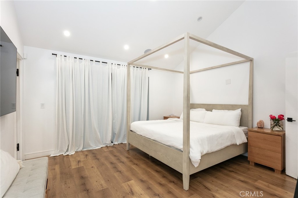 7127 Forest Hills Road West Hills, CA 91307 - Photo 15 of 37 a bedroom with a bed and a chandelier