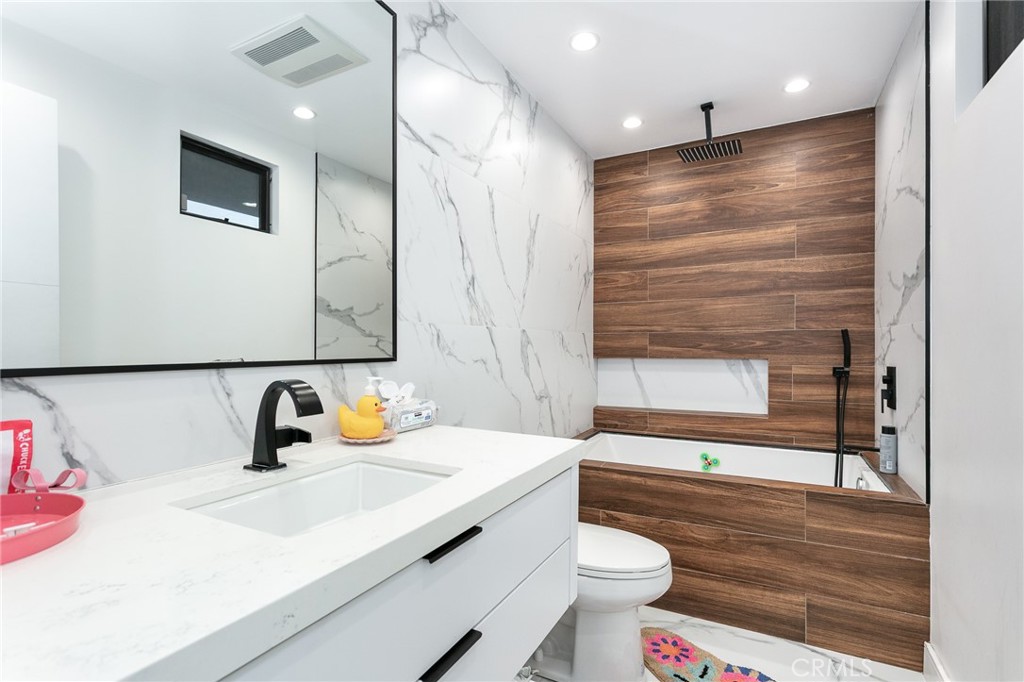 7127 Forest Hills Road West Hills, CA 91307 - Photo 21 of 37 a bathroom with a sink a toilet and a large mirror