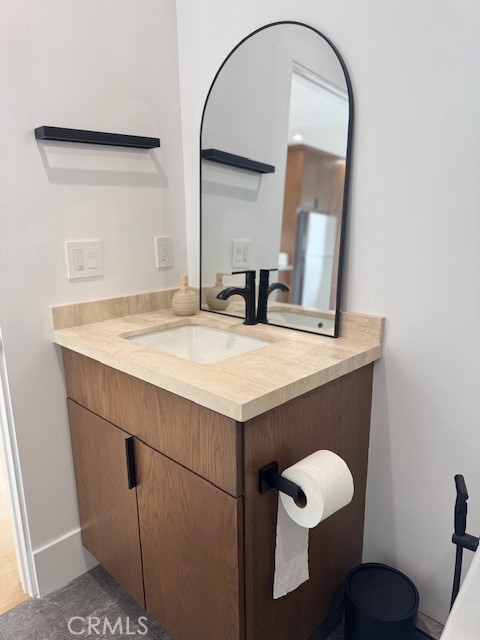 7127 Forest Hills Road West Hills, CA 91307 - Photo 25 of 37 a bathroom with a sink a toilet and a mirror