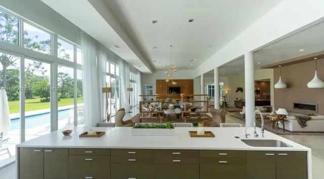 a dining hall with stainless steel appliances a dining table and chairs