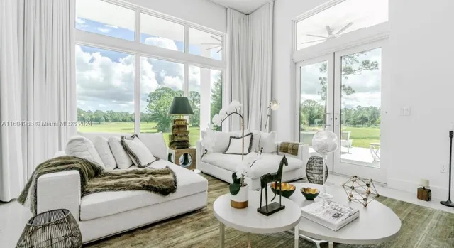 a spacious bedroom with a bed a glass window and a glass door