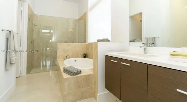 a bedroom with a bed and a large mirror