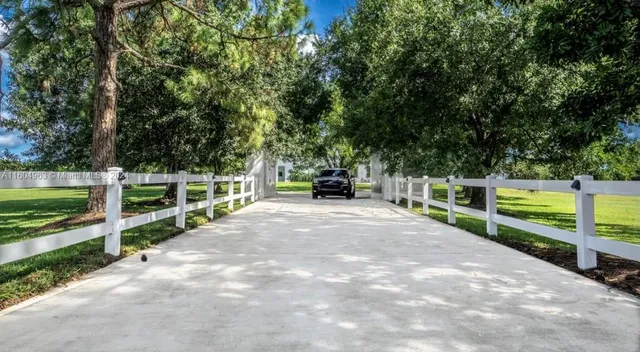 a backyard of a house with plants and outdoor seating