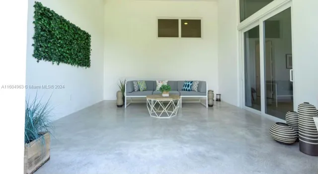 a view of a patio with couches chairs and a yard