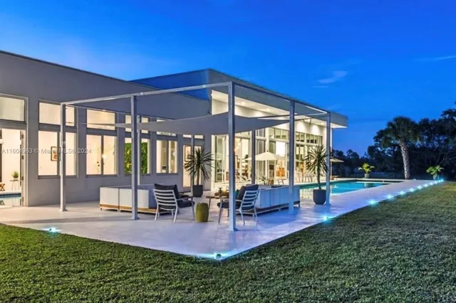 a view of a patio with table and chairs and potted plants