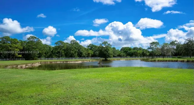 a front view of a house with a big yard