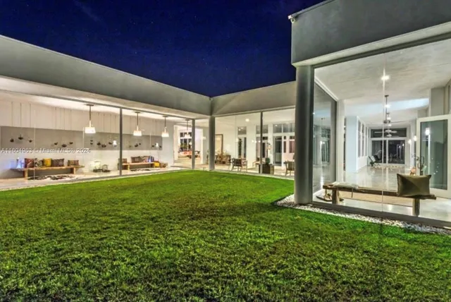 a view of swimming pool in a yard with green space