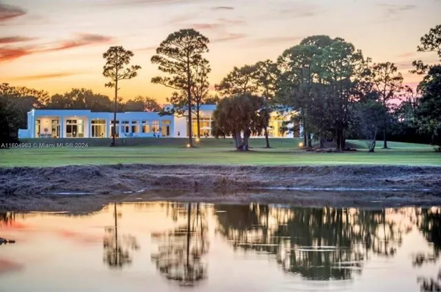 a front view of a house with a garden and yard