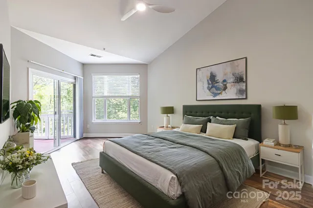 a bedroom with a large bed and a large window