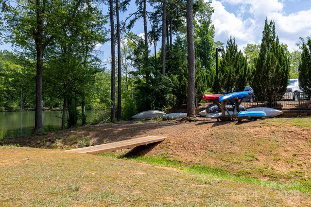a view of a lake with a bench and trees around
